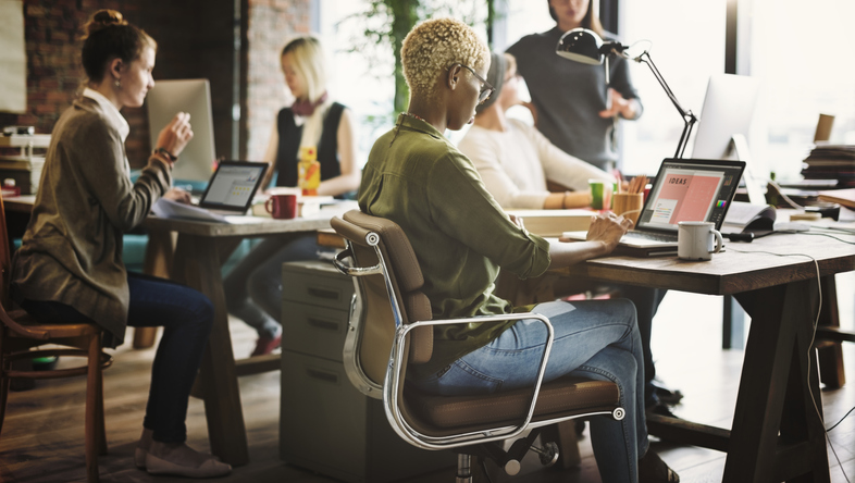 Woman using laptop and engaging in leadership development 